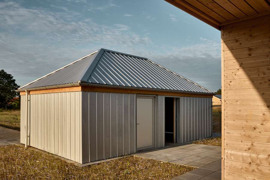 The rib sheets of Jordbærmarken create a rural atmosphere and inspire children to play outdoors, Børnehuset Jordbærmarken, Rodskovvej 59, 8543 Hornslet